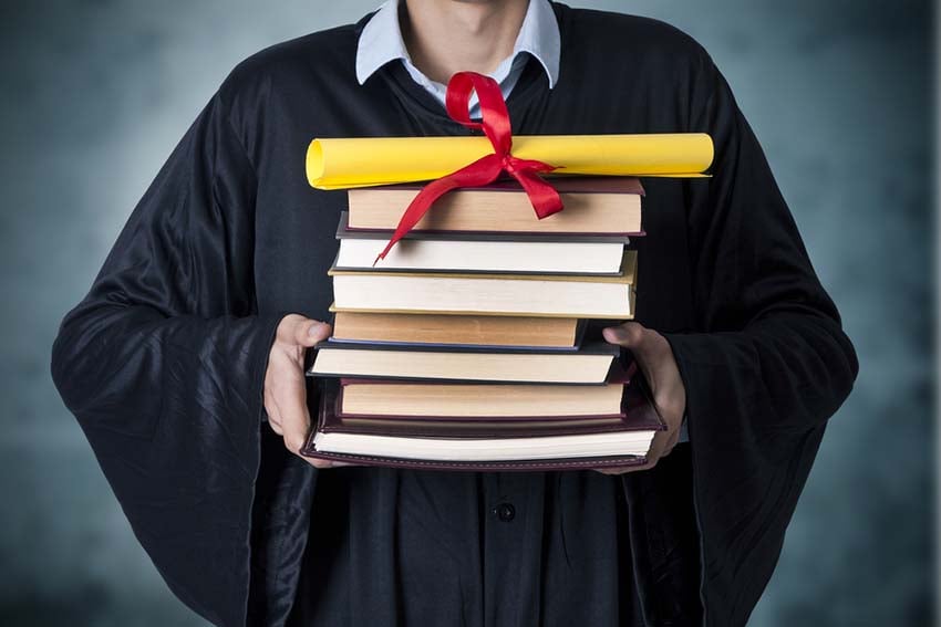 Student Holding Stack Of Books Student Holding Stack Of Books
