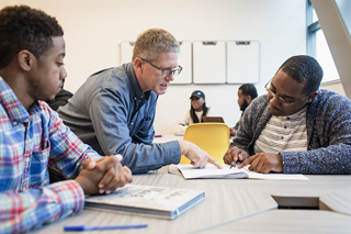 Counselor helping students in classroom